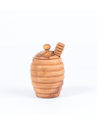 Wooden jar and ladle of honey