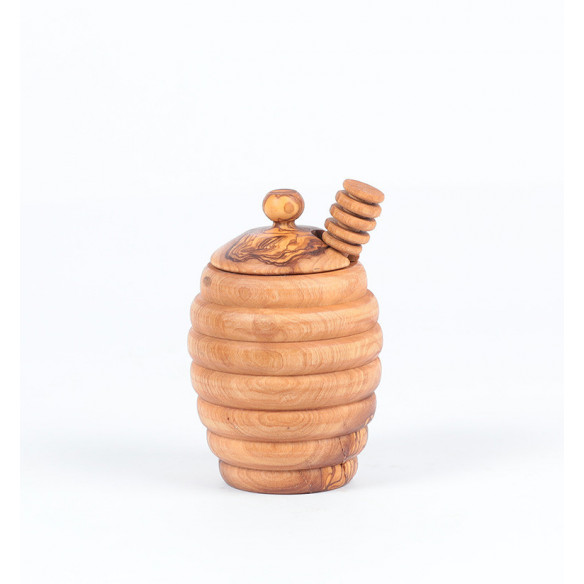 Wooden jar and ladle of honey